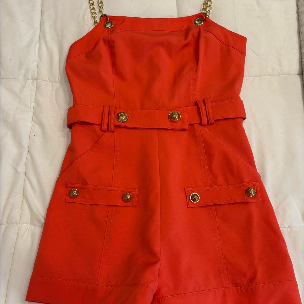 Chic Orange Romper with Gold Chain Straps and Buttons